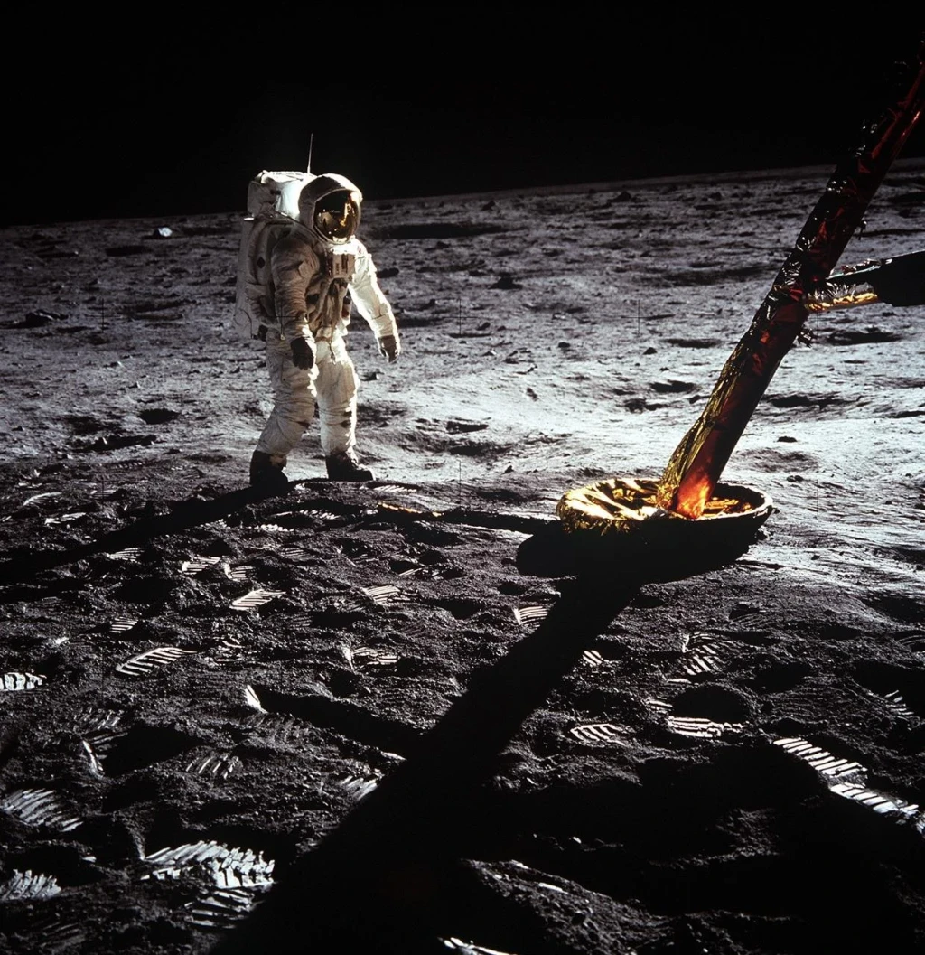 Astronaut Edwin Aldrin walks on lunar surface near leg of Lunar Module, from The Moon
