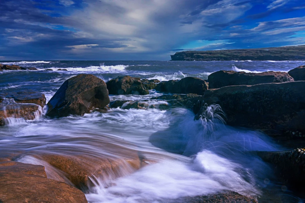 Waves and Rocks, from Tides: The Moon Pulling at the Ocean